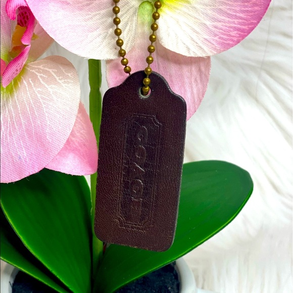 Used dark brown Coach hangtag
